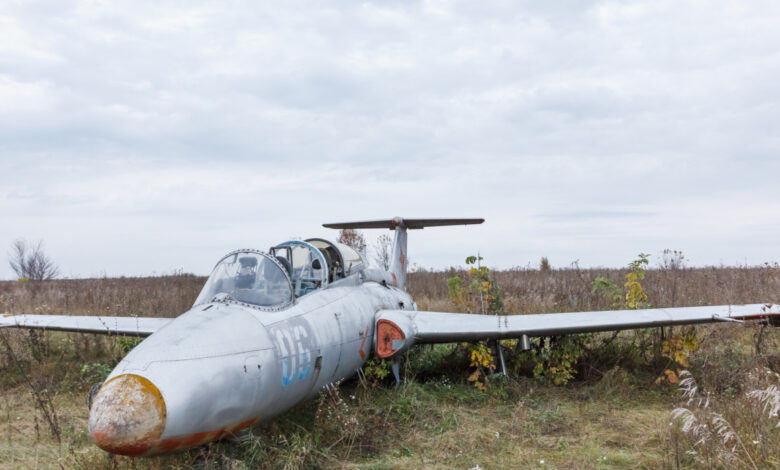 Old broken military russian airplane on the field