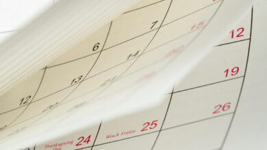 Close-up white paper desk calendar appointment and business meeting concept.