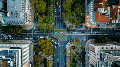 Top Down Aerial View of Cars Driving Through Intersection at Lisbon
